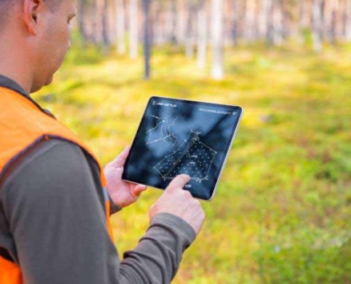 Engineer reviewing land development blueprints and site plans