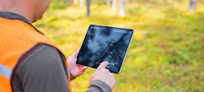 Engineer reviewing land development blueprints and site plans