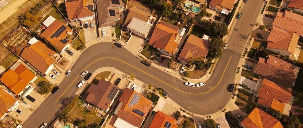 Aerial view of suburban Auckland properties showing shared driveways and housing layouts typical of cross lease titles.