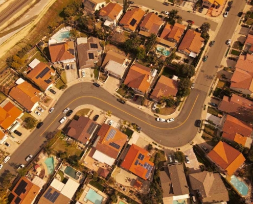 Aerial view of suburban Auckland properties showing shared driveways and housing layouts typical of cross lease titles.