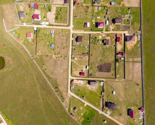 Aerial view of rural residential subdivision showing property boundaries, access roads, and scattered homes on large lifestyle sections in New Zealand.