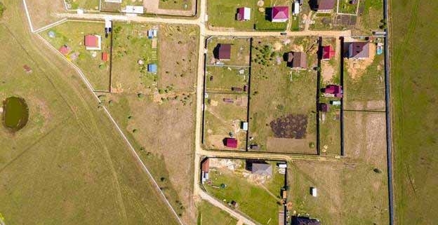 Aerial view of rural residential subdivision showing property boundaries, access roads, and scattered homes on large lifestyle sections in New Zealand.