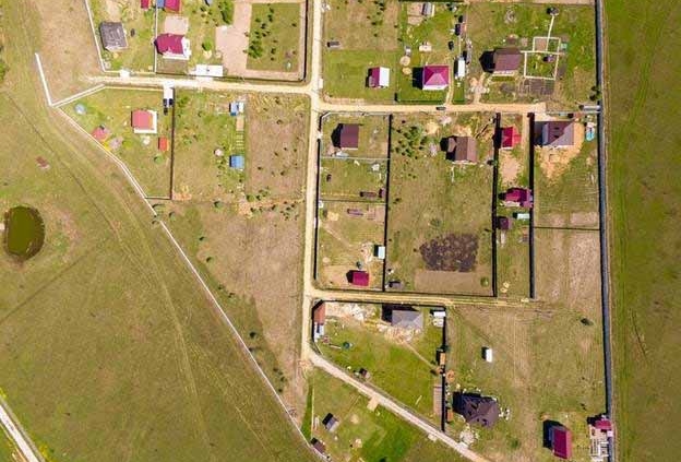 Aerial view of rural residential subdivision showing property boundaries, access roads, and scattered homes on large lifestyle sections in New Zealand.