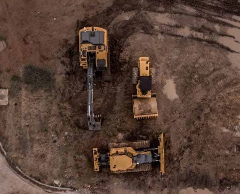 Aerial view of earthmoving machinery preparing a land development site in New Zealand