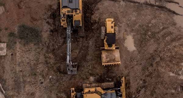 Aerial view of earthmoving machinery preparing a land development site in New Zealand