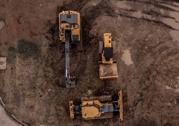 Aerial view of earthmoving machinery preparing a land development site in New Zealand