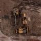 Aerial view of earthmoving machinery preparing a land development site in New Zealand